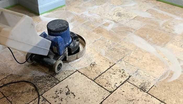 travertine floor being rinsed to remove slurry and cleaning residue